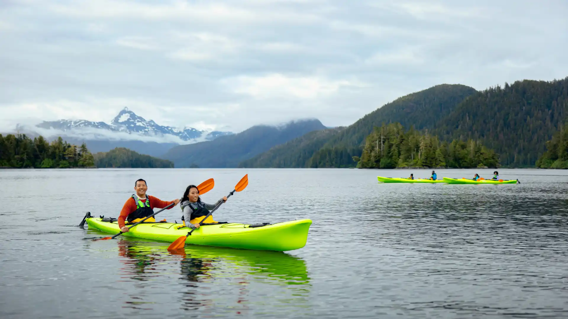 Adventure traveler kayaking through Alaska’s glacier-fed waters.